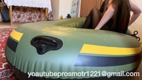 Nastya in black tights tramples on a large inflatable boat, steps with all her weight, presses, walks, beautiful legs, ass