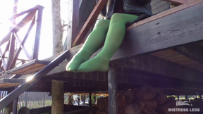 Goddess in green pantyhose teases with her feet on the porch