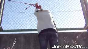 Charming Japanese  tied to fence pees herself so much