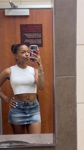 Woman in white tank top and denim skirt