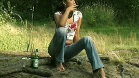 Marvelous skinny Russian girl poses topless in the forest and pisses