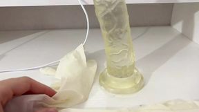 I give a handjob to the dildo with oily hands in medical white gloves