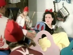 Snow White plays with a thick long candle for her seven dwarves