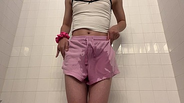 Sissy ladyboy wets her pink shorts