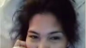 Messy haired a bit lazy but quite nice Asian girl was playing on camera