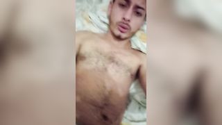 Latina hunk with straight hair strokes himself to orgasm in hot cama