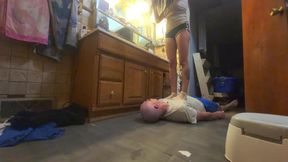 Chrissy drying her hair while standing on slaves belly and chest