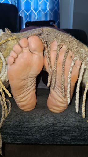 Removing the covers to reveal her cute, tired feet