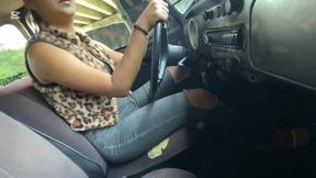 Dalilah drives down the highway in high heels