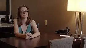 An artist gets painted by a draped model