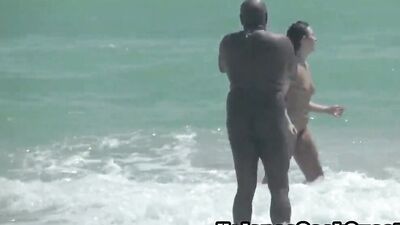 Curvy amateur MILF caught going down and dirty with her black partner on the beach