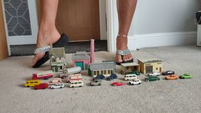 Nikkichick crushes buildings & many small cars in flip flops with painted toe nails toy cars crush close ground view