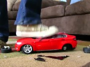 Red Car Crushed by Cali Logan's Sneakers