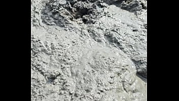 Solo Male Wading Barefoot in Lakebed of Mud