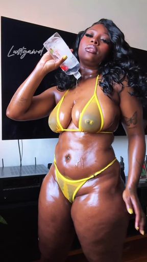 Black woman in bikini holding drink