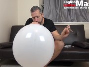 Guy jerks and smokes cigar while blowing, popping and bursting huge balloons PREVIEW