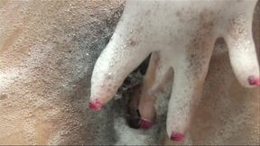 Caressing her sexy body in a bath