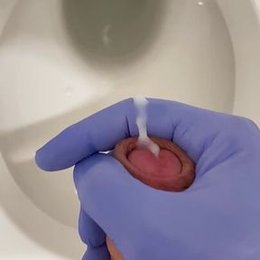 Doctor is jerking off with latex gloves at a toilet in Hospital