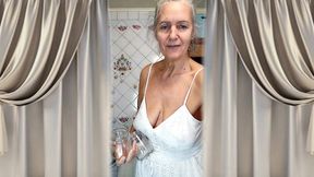 Real home solo of a mature woman in a small cozy kitchen.