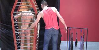 Flogging experience for a sub in that cage