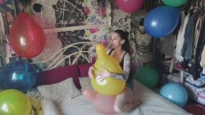Mishel playing with balloons in her room