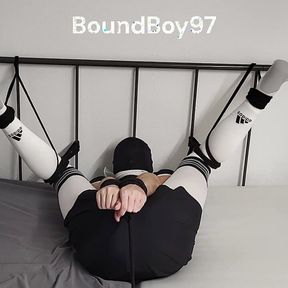 Soccer Player struggling while tied up to the bed.