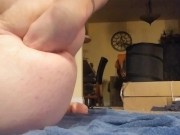 Stuffing a large toy in my ass followed by my fist.