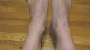 My bare legs rest on the tabletop.