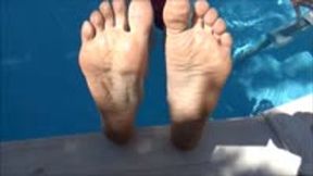 He films my feet and wrinkled soles while i'm chilling in a swimming pool